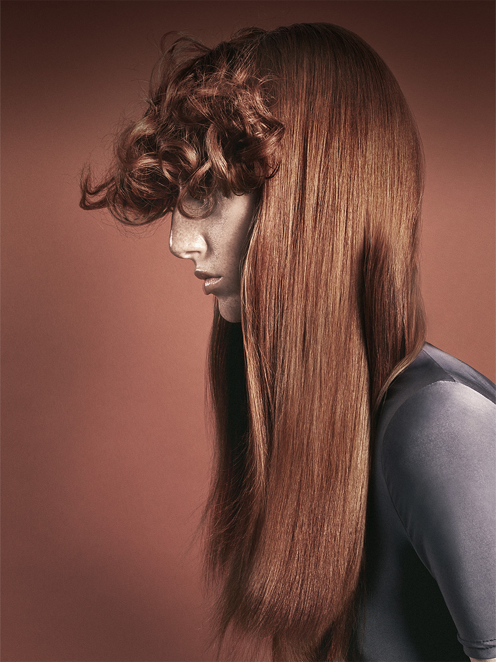 Cos Sakkas - BHA British Hairdresser of the Year 2025 - Long, Sleek Auburn Hair with Tightly Curled, Voluminous Fringe 