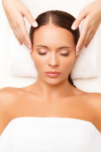 Face Massage. Close-up of a Young Woman Getting Spa Treatment.