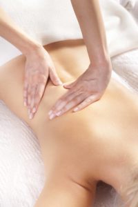 woman giving back massage to a girl